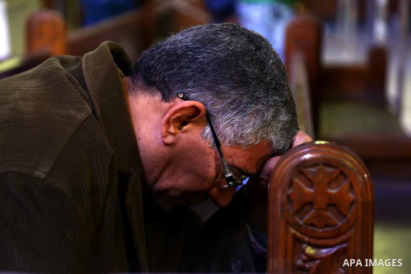 An Egyptian Coptic man attends a mass led by Egypt's Coptic Pope Tawadros II to honor the memory of the Egyptian Coptic Christians murdered by Islamic State (IS) group militants in Libya, at Saint-Mark's Coptic Cathedral...