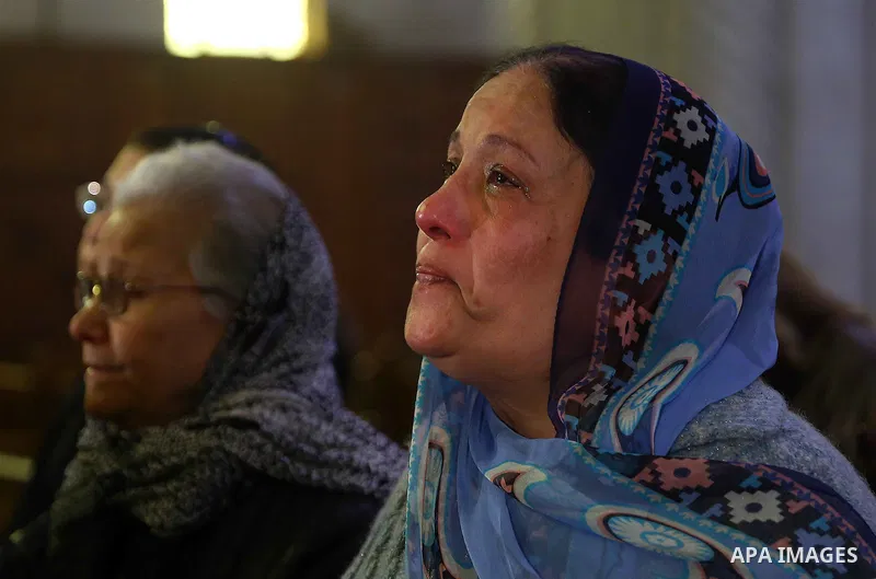 An Egyptian Coptic woman attends a mass led by Egypt's Coptic Pope Tawadros II to honor the memory of the Egyptian Coptic Christians murdered by Islamic State (IS) group militants in Libya, at Saint-Mark's Coptic Cathedr...