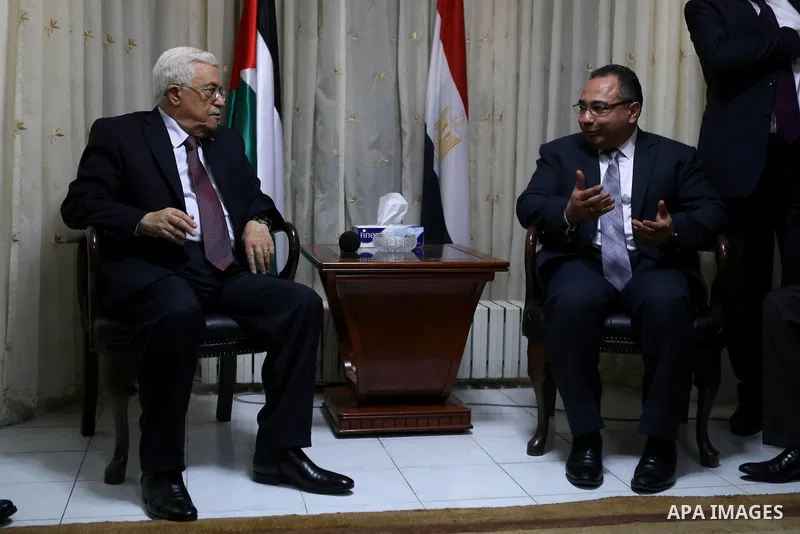 Palestinian President Mahmoud Abbas offers his condolences to the Egyptian Ambassador in Palestinian Authority Wael Atiya, in the West Bank city of Ramallah February 17, 2015. Egyptian President Abdel Fattah Al-Sisi call...