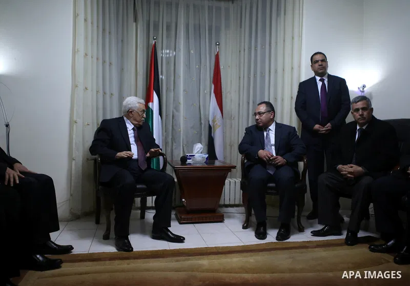 Palestinian President Mahmoud Abbas offers his condolences to the Egyptian Ambassador in Palestinian Authority Wael Atiya, in the West Bank city of Ramallah February 17, 2015. Egyptian President Abdel Fattah Al-Sisi call...