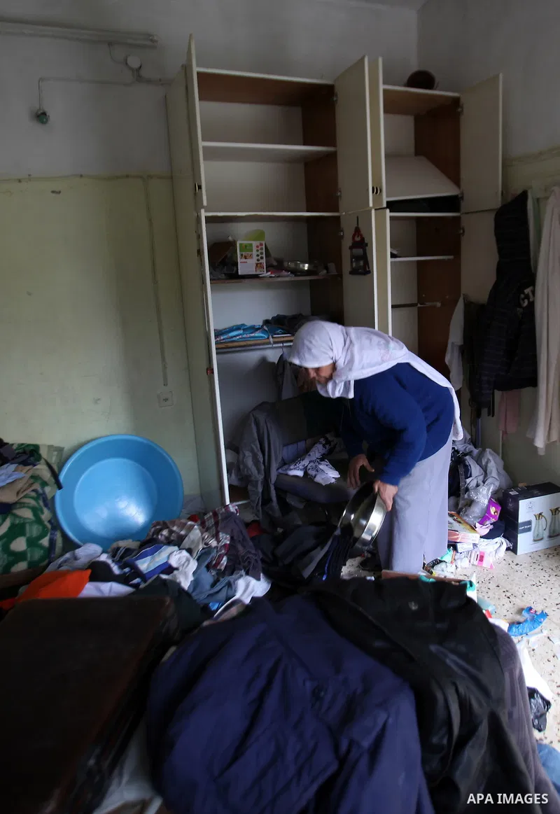 A Palestinian woman inspects the damages at her house after an Israeli military operation, in the West Bank village of Yatma south of Nablus Feb. 18, 2015. Israeli troops stormed three Palestinian villages in Nablus dist...