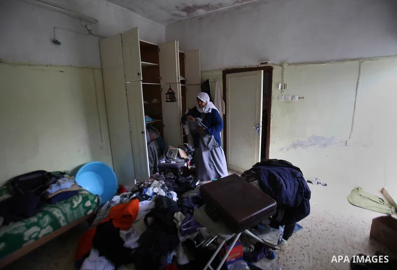 A Palestinian woman inspects the damages at her house after an Israeli military operation, in the West Bank village of Yatma south of Nablus Feb. 18, 2015. Israeli troops stormed three Palestinian villages in Nablus dist...