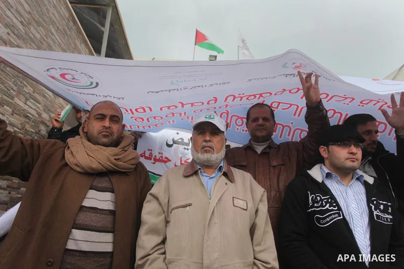 Palestinian employees of former Palestinian government take part a protest demanding their salaries to be paid, in front of the Legislative Council in Gaza city on February 18, 2015. Some 40,000 civil servants employed b...