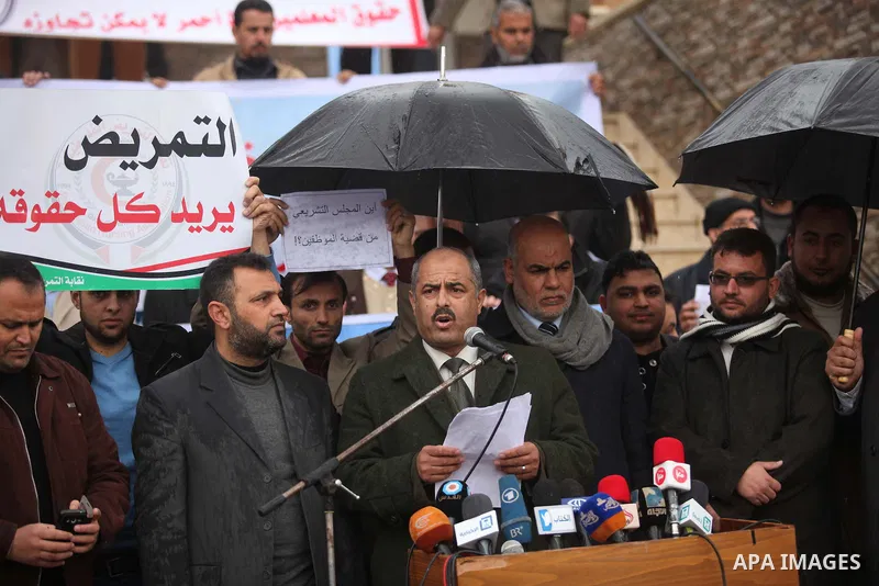 Former head of the union staff in Gaza, Mohammed Siam speaks during a protest demanding their salaries to be paid, in front of the Legislative Council in Gaza city on February 18, 2015. Some 40,000 civil servants employe...