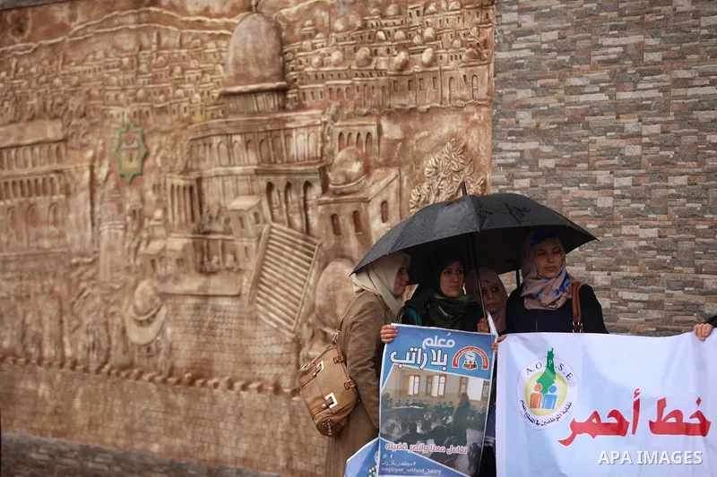Palestinian employees of former Palestinian government take part a protest demanding their salaries to be paid, in front of the Legislative Council in Gaza city on February 18, 2015. Some 40,000 civil servants employed b...