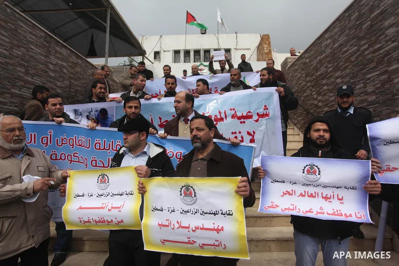 Palestinian employees of former Palestinian government take part a protest demanding their salaries to be paid, in front of the Legislative Council in Gaza city on February 18, 2015. Some 40,000 civil servants employed b...