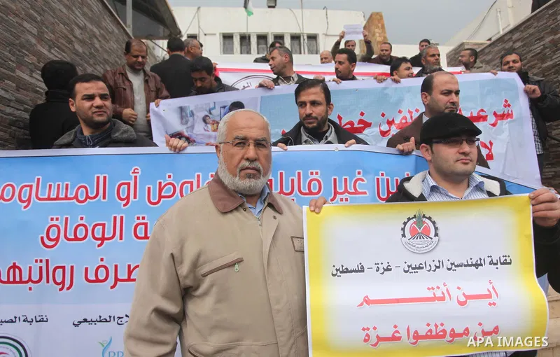 Palestinian employees of former Palestinian government take part a protest demanding their salaries to be paid, in front of the Legislative Council in Gaza city on February 18, 2015. Some 40,000 civil servants employed b...