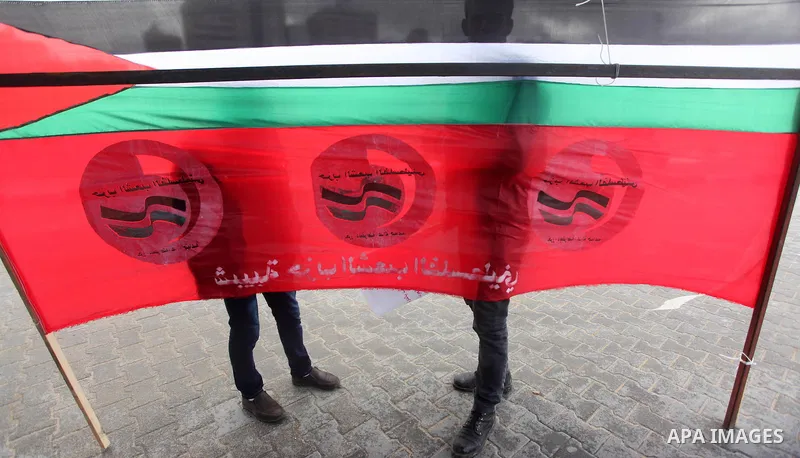 Supporters of Palestinian People's Party take part a protest demanding for reconstruction of the houses which were destroyed during the recent Israeli war, at the seaport near the coast of Gaza city, February 18, 2015. A...