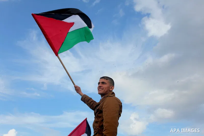 A supporter of Palestinian People's Party takes part a protest demanding for reconstruction of the houses which were destroyed during the recent Israeli war, at the seaport near the coast of Gaza city, February 18, 2015....