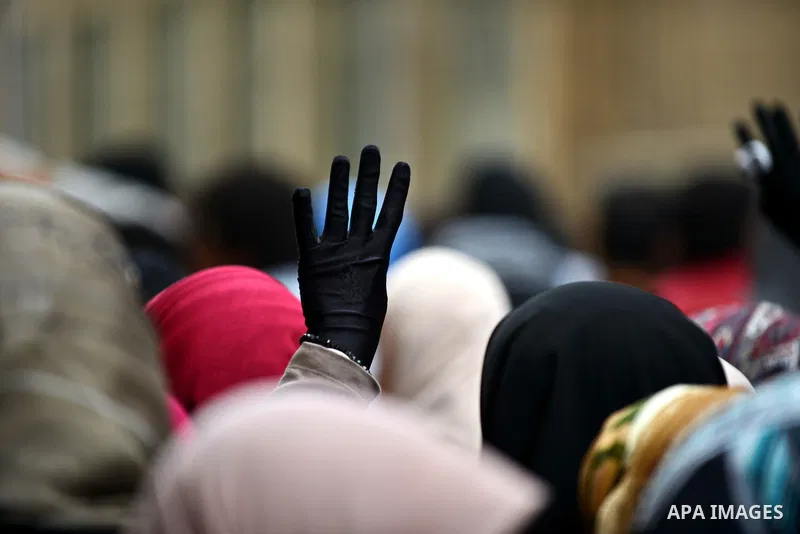 An Egyptian student who support ousted President Mohamed Morsi and the Muslim Brotherhood, flashes Rabaa sign during protest against the military rule, in Cairo University on February 18, 2015. Due to the escalation of s...