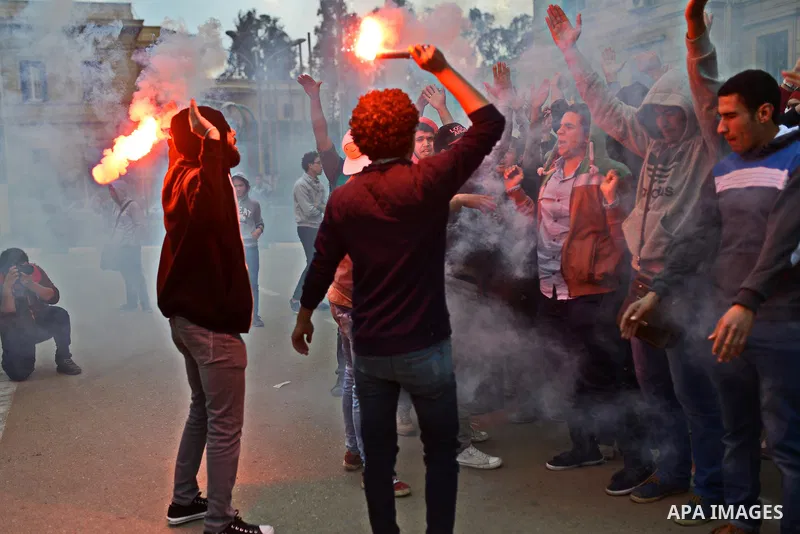 Egyptian students who are support ousted President Mohamed Morsi and the Muslim Brotherhood light up flares as others protest against the military rule, in Cairo University on February 18, 2015. Due to the escalation of...