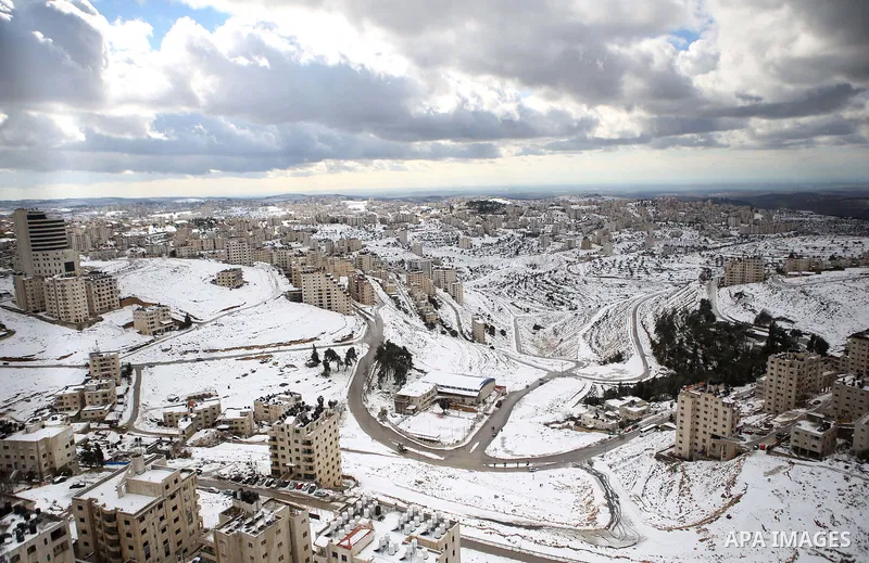 A general view shows the snow-covered West Bank city of Ramallah on February 20, 2015. A heavy winter storm hit parts of the Middle East on Friday, shutting down roads leading in and out of Jerusalem and sprinkling areas...