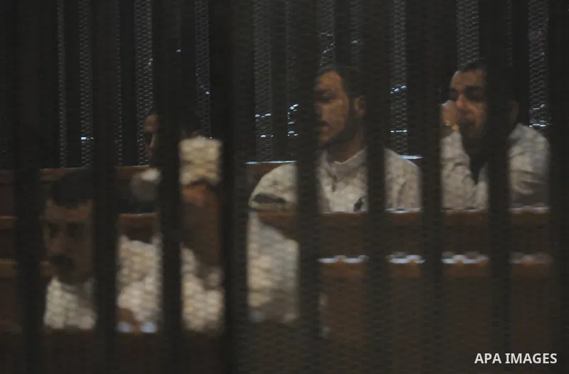 Suspects in the 'Port Said Massacre' case, stand in a courtroom cage during their trial in Cairo on February 21, 2015. The defendants were originally given sentences ranging from 15 years to life in prison. They were con...