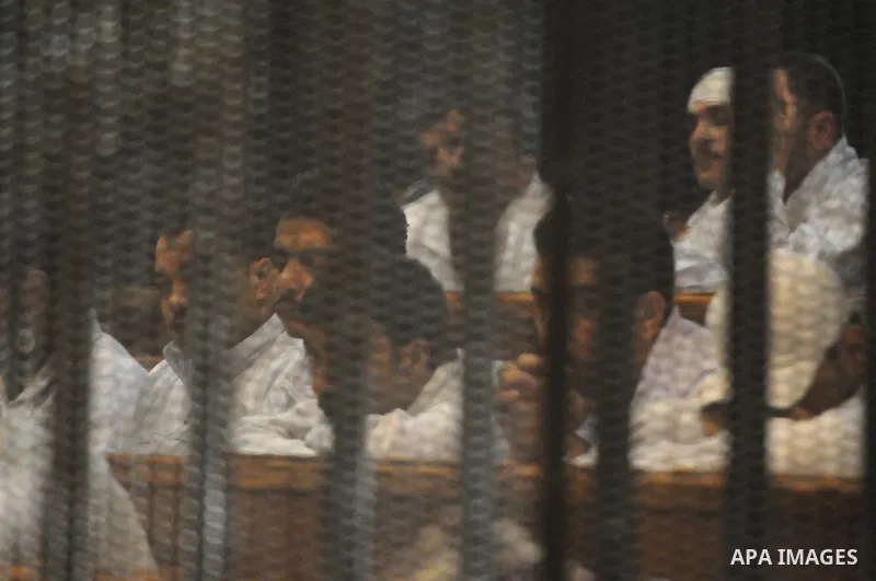 Suspects in the 'Port Said Massacre' case, stand in a courtroom cage during their trial in Cairo on February 21, 2015. The defendants were originally given sentences ranging from 15 years to life in prison. They were con...
