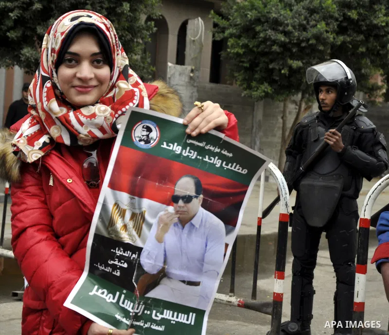 Egyptian woman holds a poster of Egyptian President Abdel Fattah al-Sissi during a protest in front of the Qatari embassy in Cairo, Egypt, 21 February 2015. Several people protested outside Qatar's embassy, after Qatar r...