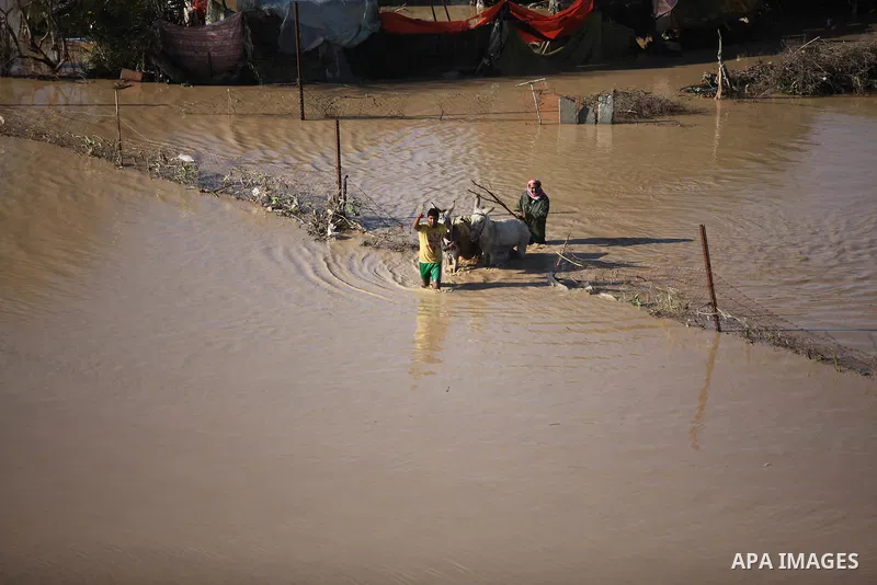 Palestinians ride donkey cart as they evacuate their animals in the village of Al-Moghraga after it was flooded by rain water, near central Gaza Strip February 22, 2015. Palestinian authorities said the Israeli army open...