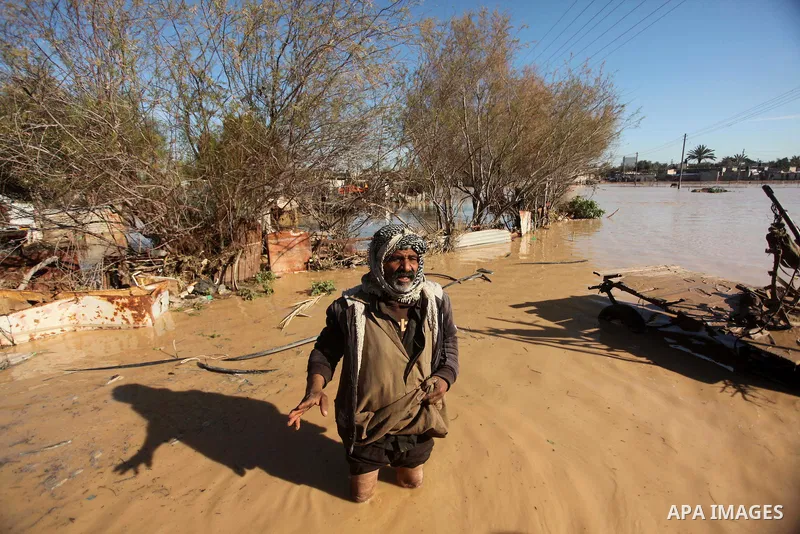 A Palestinian Bedouin man makes his way despite the water in an area that is flooded after Israel opened the gates of a dam along its border with the Gaza Strip on February 22, 2015 in the village of al-Mughraqa, south o...