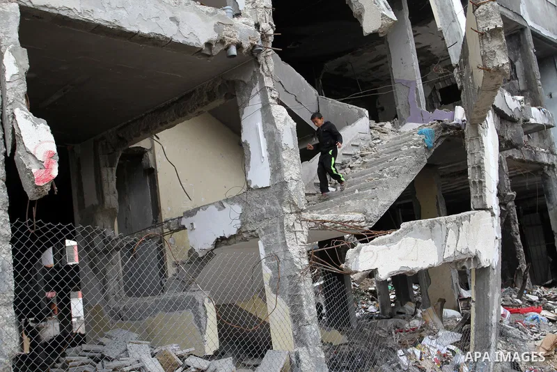 A Palestinian boy walks on the rubbles of his family's house, which was destoryed during the recent Israeli war, in Rafah in the southern Gaza strip, February 22, 2015. At least 100,000 Palestinians are still living with...