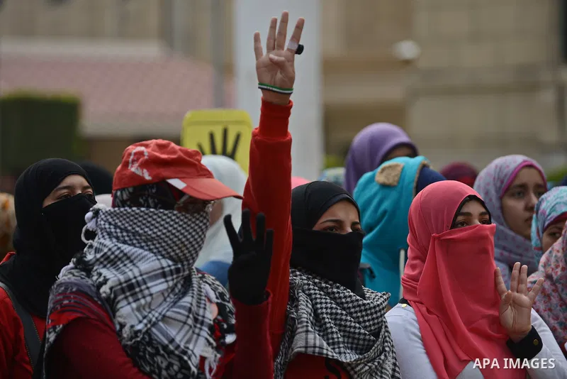An Egyptian student who support ousted President Mohamed Morsi and the Muslim Brotherhood, flashes Rabaa sign during protest against the military rule, in Cairo University on February 22, 2015. Due to the escalation of s...