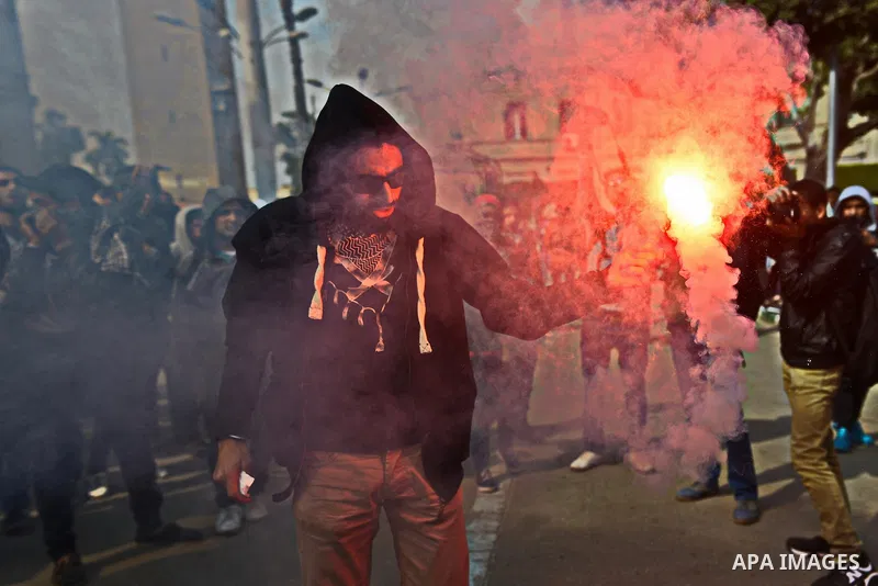 An Egyptian student who support ousted President Mohamed Morsi and the Muslim Brotherhood lights up flares as others protest against the military rule, in Cairo University on February 22, 2015. Due to the escalation of s...