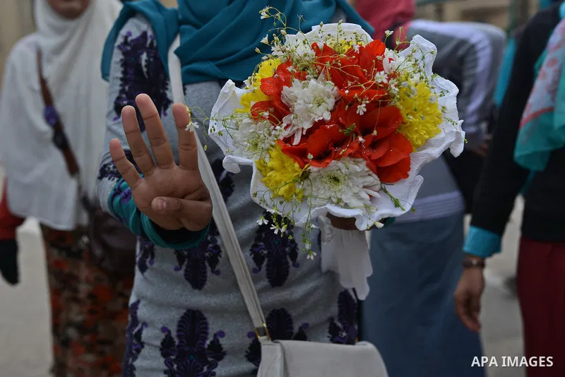 An Egyptian student who support ousted President Mohamed Morsi and the Muslim Brotherhood, flashes Rabaa sign during protest against the military rule, in Cairo University on February 22, 2015. Due to the escalation of s...