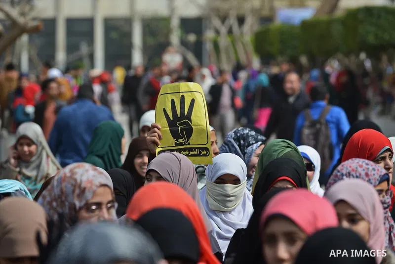 An Egyptian student who support ousted President Mohamed Morsi and the Muslim Brotherhood, holds Rabaa sign during protest against the military rule, in Cairo University on February 22, 2015. Due to the escalation of stu...