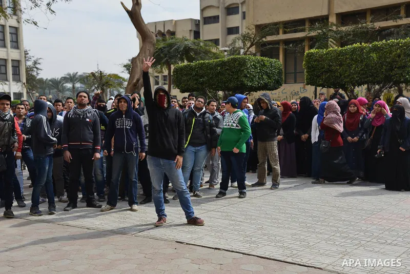 Egyptian students who are support ousted President Mohamed Morsi and the Muslim Brotherhood shout slogans during protest against the military rule, in Cairo University on February 22, 2015. Due to the escalation of stude...