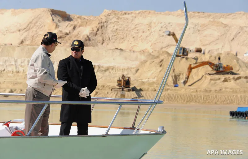 Egyptian President Abdel Fattah al-Sisi speaks to Mohab Memish, head of the Suez Canal Authority, about the Suez Canal project during his visit to the Suez Canal, February 22, 2015. APAIMAGES/The Egyptian Presidency
