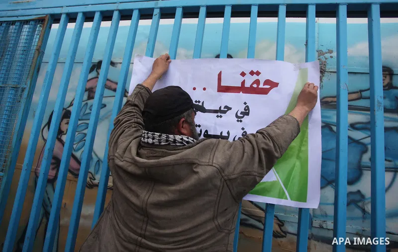 Palestinian owners of houses which were destroyed during the recent Israeli war, take part in a rally demanding for reconstruction of their houses, in front of UNRWA headquarter in Gaza city, February 23, 2015. At least...