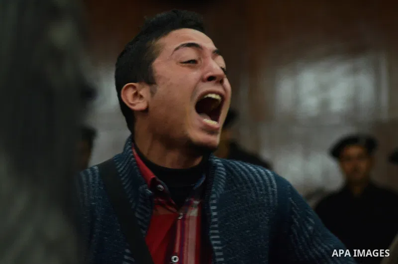 Relatives and supporters of Egyptian activist Alaa Abdel Fattah react after the verdict in his trial at a police institute in Cairo's Tora prison on February 23, 2015. Fattah, a leading dissident in the 2011 uprising tha...