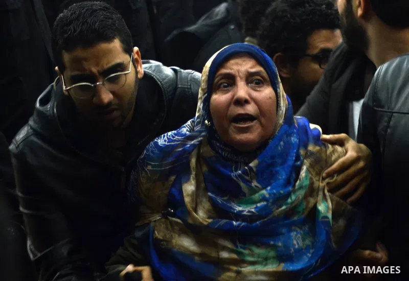 Relatives and supporters of Egyptian activist Alaa Abdel Fattah react after the verdict in his trial at a police institute in Cairo's Tora prison on February 23, 2015. Fattah, a leading dissident in the 2011 uprising tha...