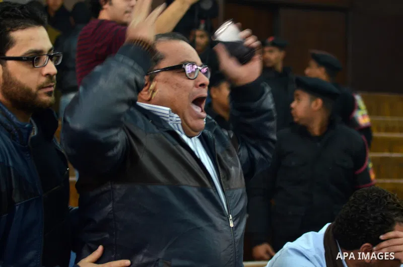 Relatives and supporters of Egyptian activist Alaa Abdel Fattah react after the verdict in his trial at a police institute in Cairo's Tora prison on February 23, 2015. Fattah, a leading dissident in the 2011 uprising tha...