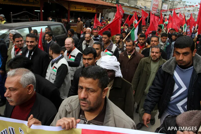 Palestinians chant slogans during a rally marking the 46th anniversary of the founding of the Democratic Front for the Liberation of Palestine (DFLP), in Rafah in the southern Gaza Strip February 23, 2015. Photo by Abed...