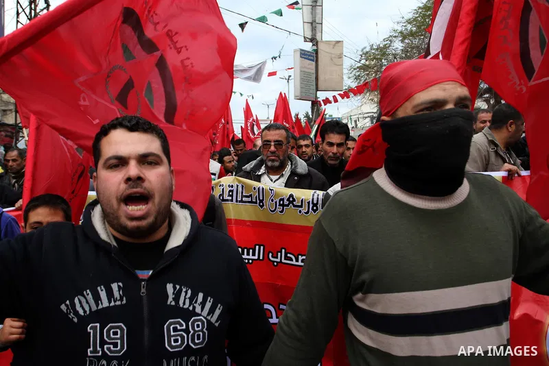 Palestinians chant slogans during a rally marking the 46th anniversary of the founding of the Democratic Front for the Liberation of Palestine (DFLP), in Rafah in the southern Gaza Strip February 23, 2015. Photo by Abed...
