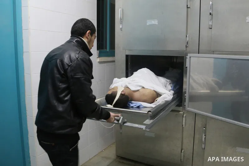The body of Palestinian Jihad al-Jaafari, 19, who was shot dead by Israeli soldiers, lies in a bed, at a hospital morgue, in the West Bank city of Bethlehem, on February 24, 2015. Israeli soldiers shot dead al-Jaafari, o...