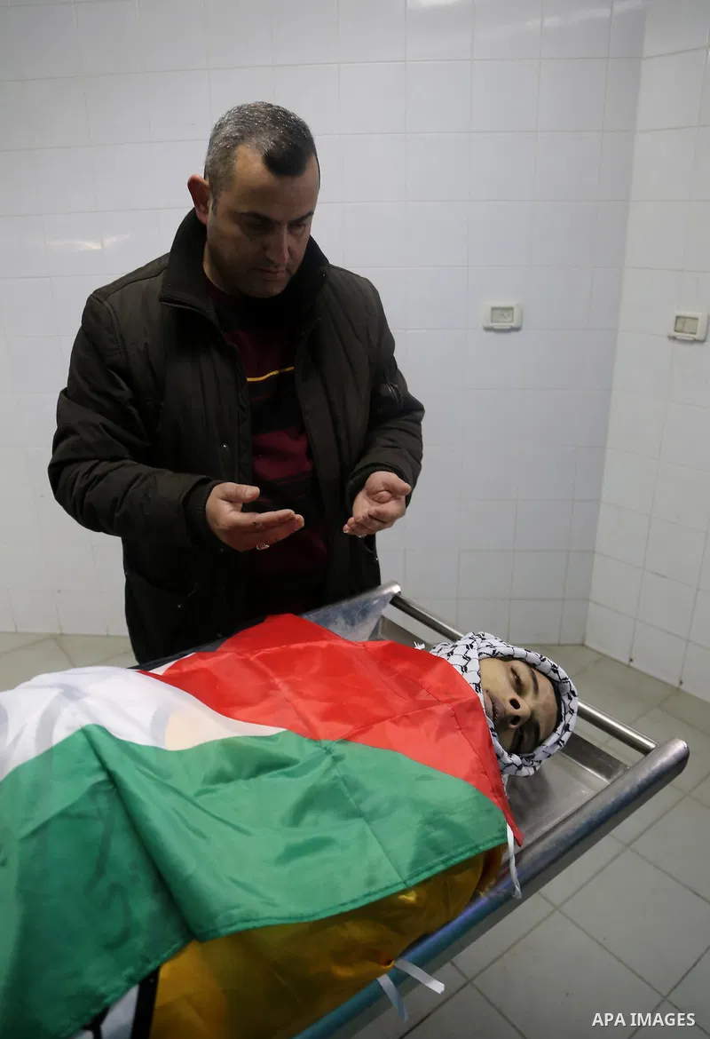 A Relative mourns over the body of Palestinian Jihad al-Jaafari, 19, who was shot dead by Israeli soldiers, at a hospital morgue, in the West Bank city of Bethlehem, on February 24, 2015. Israeli soldiers shot dead al-Ja...