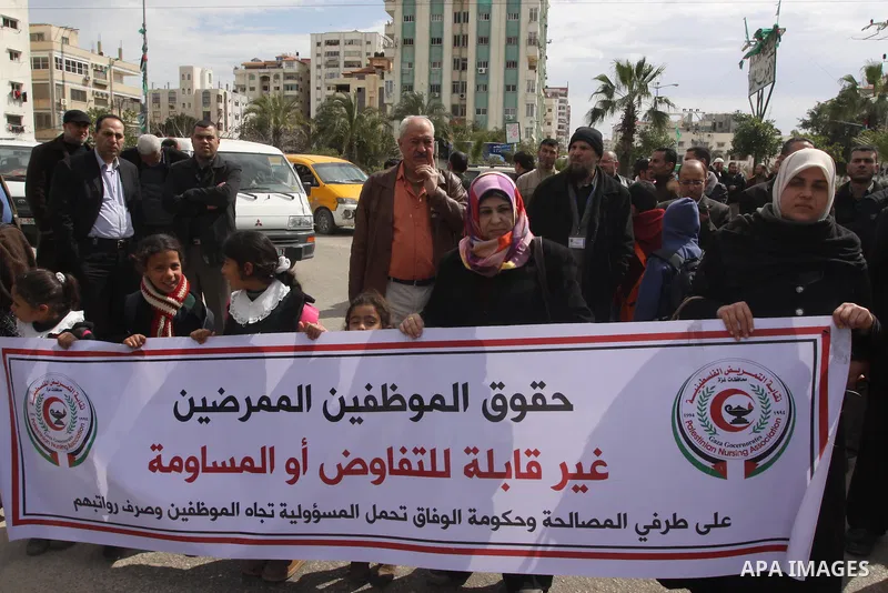 Palestinian employees of former Palestinian government take part a protest demanding their salaries to be paid, in front of the Legislative Council in Gaza city on February 24, 2015. Some 40,000 civil servants employed b...