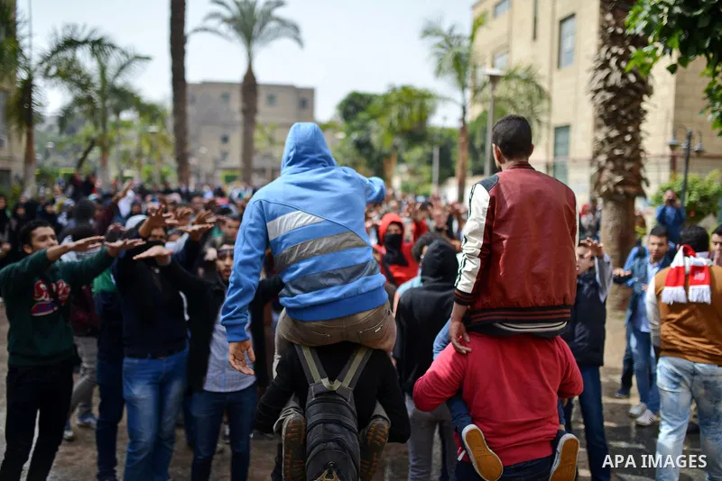 Egyptian students who are support ousted President Mohamed Morsi and the Muslim Brotherhood shout slogans during protest against the military rule, in Cairo University on February 24, 2015. Due to the escalation of stude...