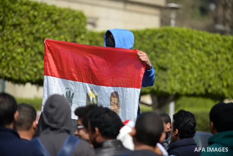 An Egyptian student who support Muslim Brotherhood, hold a flag with the picture of ousted President Mohamed Morsi during protest against the military rule, in Cairo University on February 24, 2015. Due to the escalation...