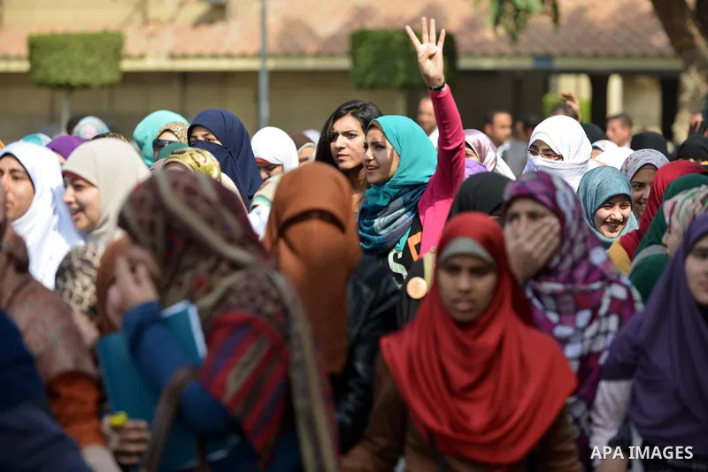 An Egyptian student who support ousted President Mohamed Morsi and the Muslim Brotherhood, flashes Rabaa sign during protest against the military rule, in Cairo University on February 24, 2015. Due to the escalation of s...