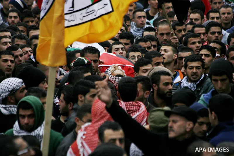 Palestinian mourners carry the body of 19-year old Palestinian Jihad al-Jaafari, who was shot dead on the roof of his house after Israeli soldiers entered the Dheishe refugee camp, near the West Bank city of Bethlehem be...
