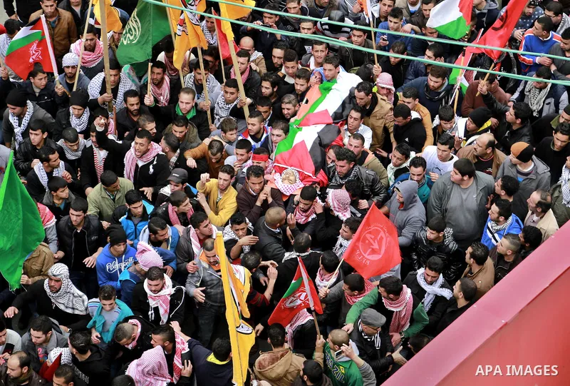 Palestinian mourners carry the body of 19-year old Palestinian Jihad al-Jaafari, who was shot dead on the roof of his house after Israeli soldiers entered the Dheishe refugee camp, near the West Bank city of Bethlehem be...