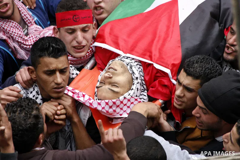 Palestinian mourners carry the body of 19-year old Palestinian Jihad al-Jaafari, who was shot dead on the roof of his house after Israeli soldiers entered the Dheishe refugee camp, near the West Bank city of Bethlehem be...