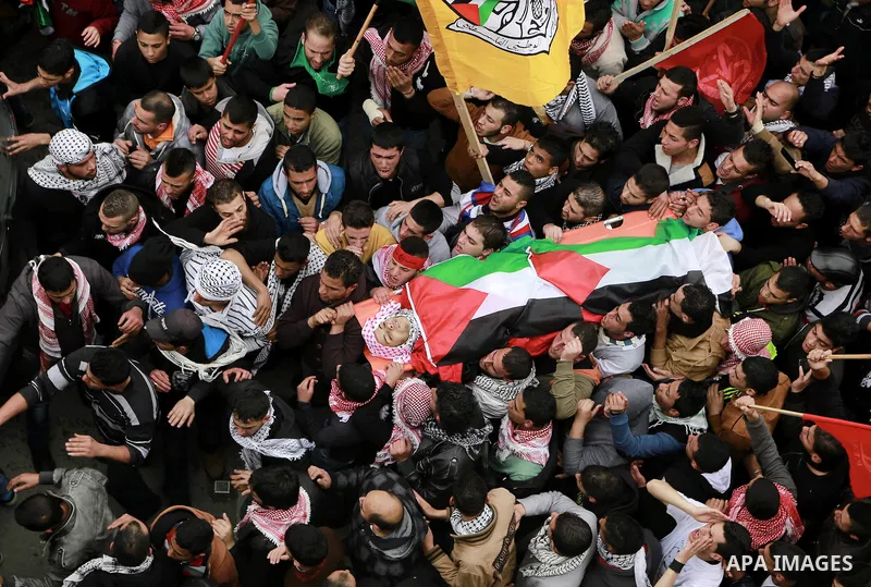 Palestinian mourners carry the body of 19-year old Palestinian Jihad al-Jaafari, who was shot dead on the roof of his house after Israeli soldiers entered the Dheishe refugee camp, near the West Bank city of Bethlehem be...