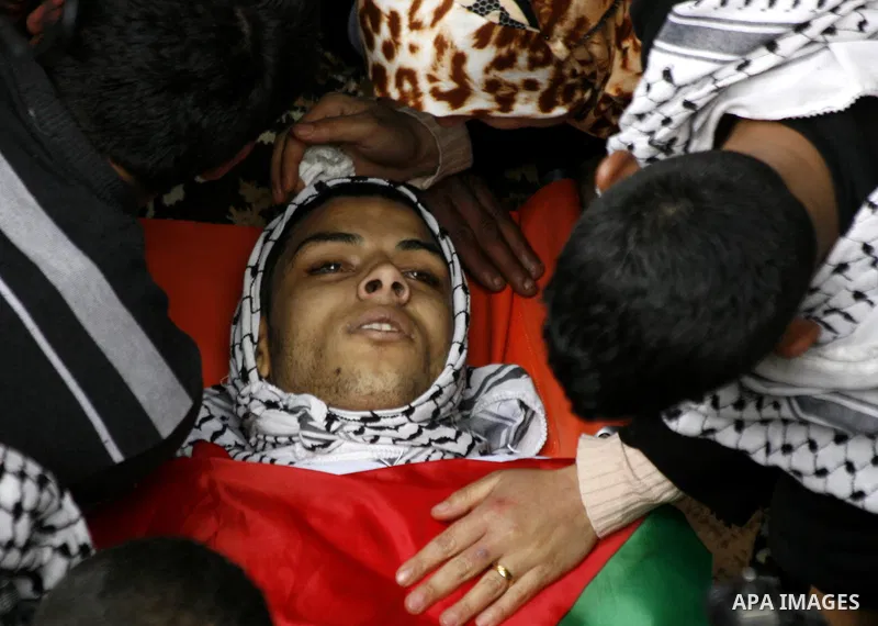 Relatives mourn over the body of 19-year old Palestinian Jihad al-Jaafari, who was shot dead on the roof of his house after Israeli soldiers entered the Dheishe refugee camp, near the West Bank city of Bethlehem before d...