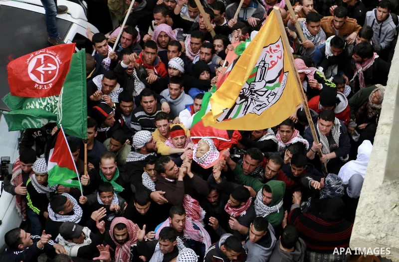Palestinian mourners carry the body of 19-year old Palestinian Jihad al-Jaafari, who was shot dead on the roof of his house after Israeli soldiers entered the Dheishe refugee camp, near the West Bank city of Bethlehem be...
