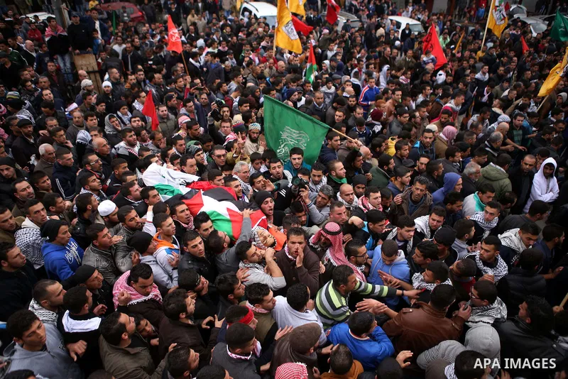 Palestinian mourners carry the body of 19-year old Palestinian Jihad al-Jaafari, who was shot dead on the roof of his house after Israeli soldiers entered the Dheishe refugee camp, near the West Bank city of Bethlehem be...