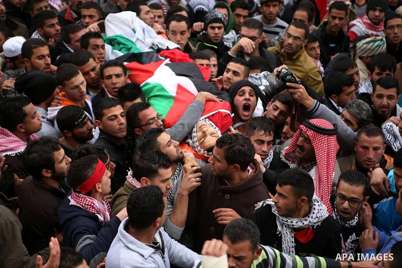 Palestinian mourners carry the body of 19-year old Palestinian Jihad al-Jaafari, who was shot dead on the roof of his house after Israeli soldiers entered the Dheishe refugee camp, near the West Bank city of Bethlehem be...