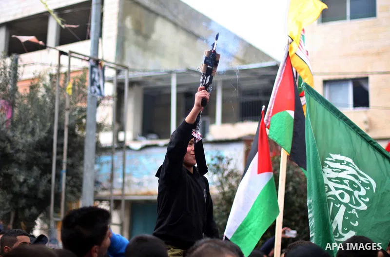 A Palestinian militant fires into air during the funeral of 19-year old Palestinian Jihad al-Jaafari, who was shot dead on the roof of his house after Israeli soldiers entered the Dheishe refugee camp, near the West Bank...