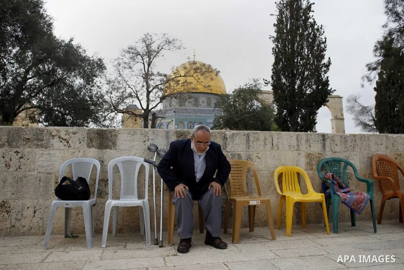 A Palestinian man prays outside al-Aqsa mosque, in the al-Aqsa mosque compound, in Jerusalem's old city, February 24, 2015. Photo by Muammar Awad